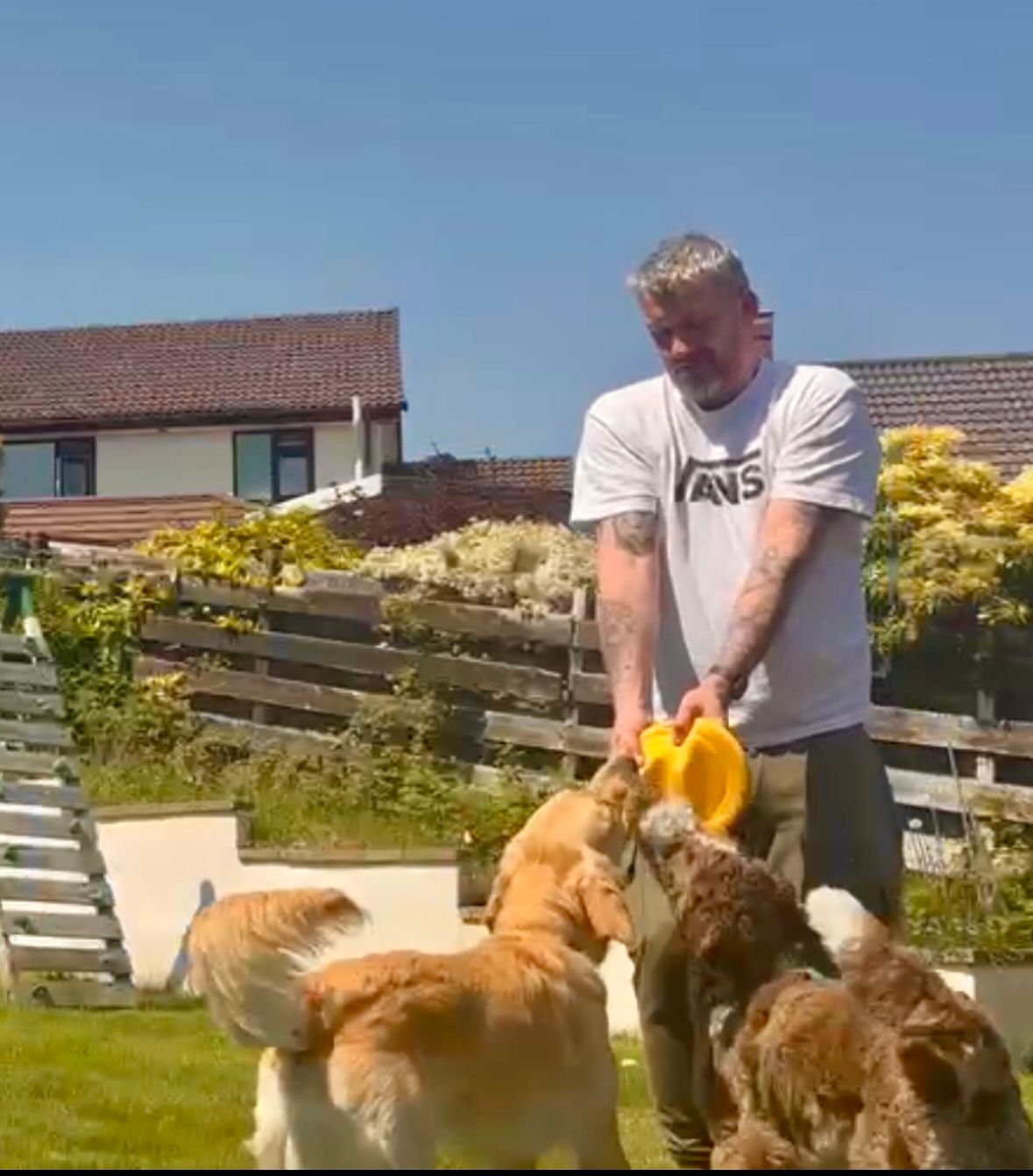Darren outdoors with a dog on the Isle of Man